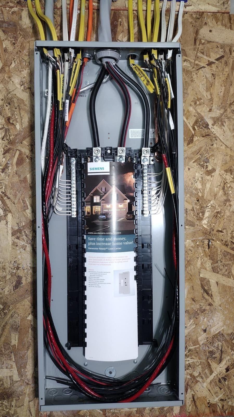 Siemens electrical panel with organized wiring and energy-saving information displayed.